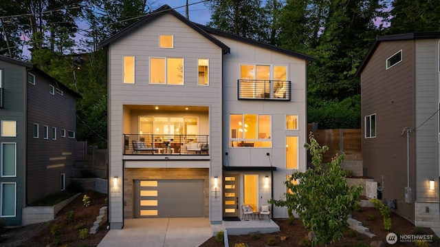 4576 22nd Ave SW, Seattle, WA 98106 - view of front facade with a balcony, an attached garage, and driveway