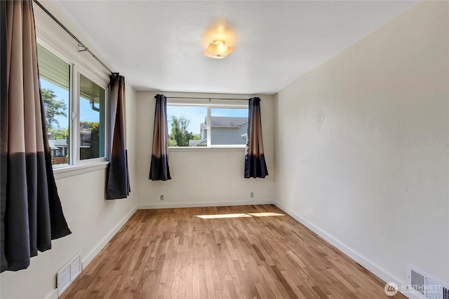 220 Alder Ave, Sumner, WA 98390 - unfurnished room featuring plenty of natural light, light wood finished floors, and baseboards