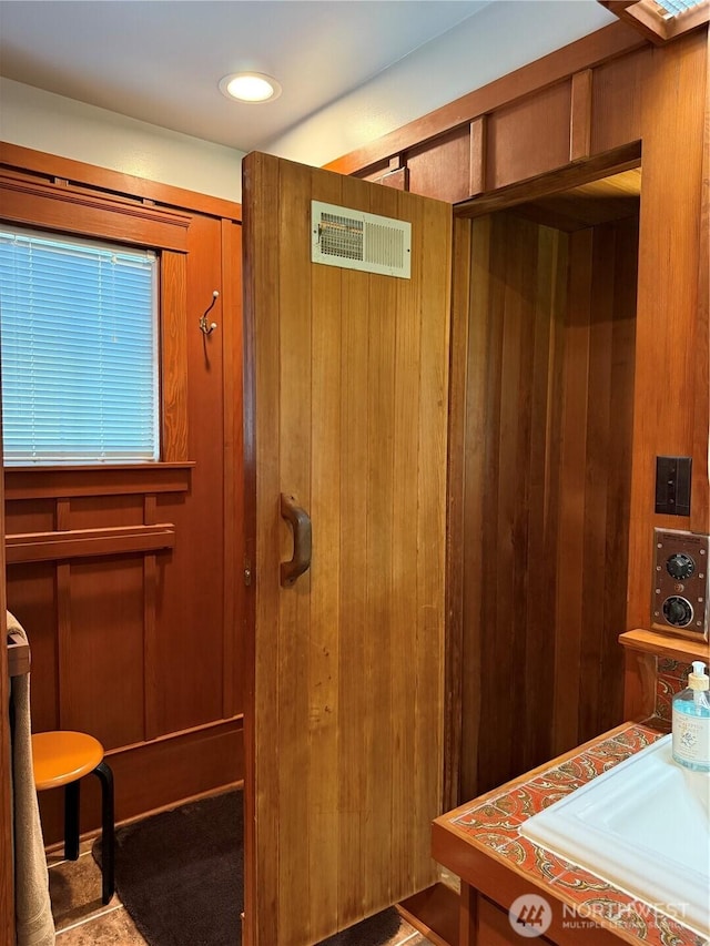 115 15th St SW, Long Beach, WA 98631 - bathroom featuring wood walls and a sink