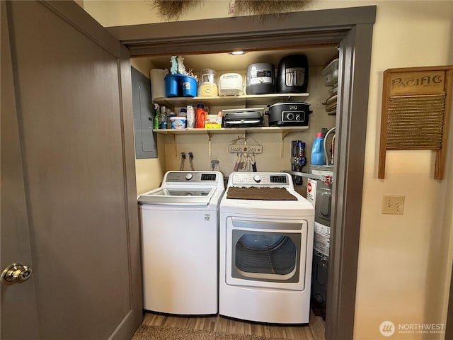 115 15th St SW, Long Beach, WA 98631 - washroom featuring washing machine and dryer, wood finished floors, electric water heater, and electric panel