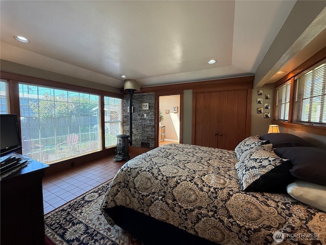 115 15th St SW, Long Beach, WA 98631 - tiled bedroom with multiple windows, recessed lighting, and a wood stove