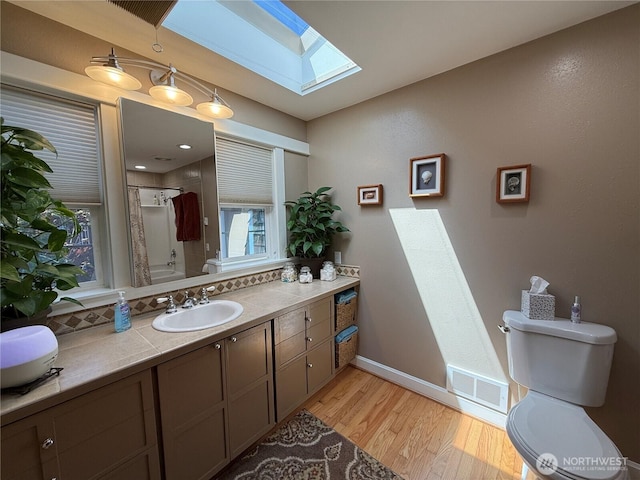 115 15th St SW, Long Beach, WA 98631 - full bath with toilet, a skylight, a shower, and wood finished floors