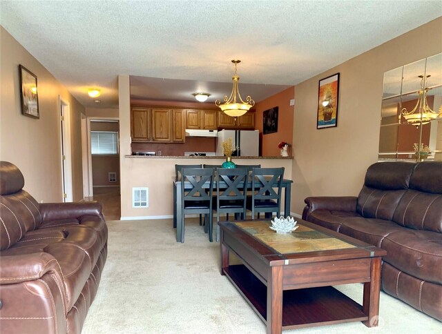 31003 14th Ave S Unit C12, Federal Way, WA 98003 - living room featuring light carpet, a textured ceiling, and a chandelier