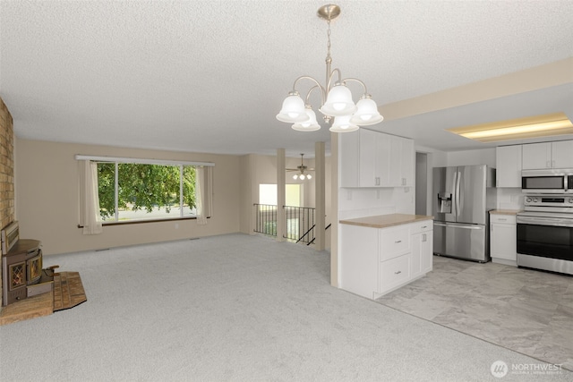 17122 40th Ave W, Lynnwood, WA 98037 - kitchen with stainless steel appliances, light countertops, a chandelier, white cabinetry, and a textured ceiling