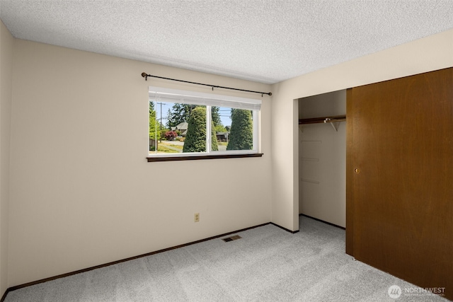 17122 40th Ave W, Lynnwood, WA 98037 - unfurnished bedroom featuring light colored carpet, a textured ceiling, a closet, and baseboards