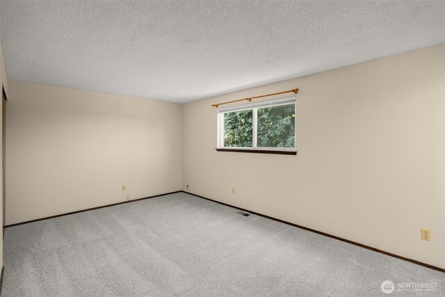 17122 40th Ave W, Lynnwood, WA 98037 - spare room featuring light colored carpet, a textured ceiling, and baseboards
