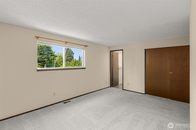 17122 40th Ave W, Lynnwood, WA 98037 - unfurnished bedroom featuring a textured ceiling, carpet flooring, and a closet