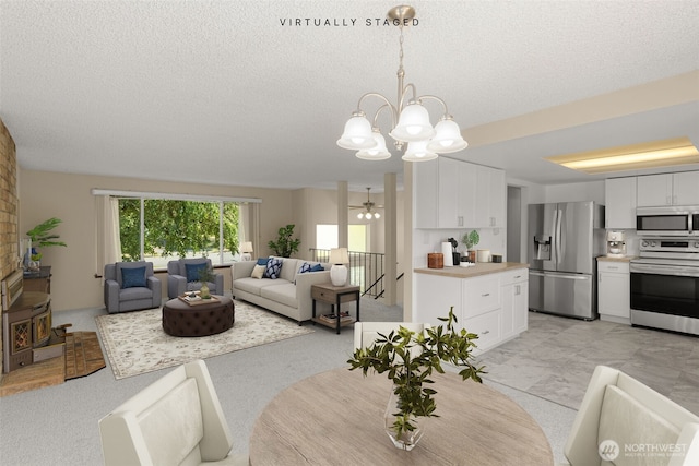 17122 40th Ave W, Lynnwood, WA 98037 - dining area with a chandelier, a textured ceiling, and a ceiling fan