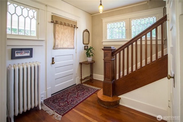 1510 Water St SW, Olympia, WA 98501 - entrance foyer with radiator, wood finished floors, stairs, crown molding, and baseboards