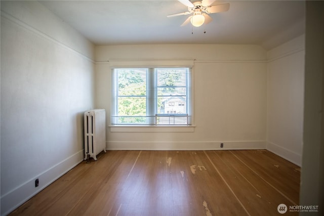 1510 Water St SW, Olympia, WA 98501 - empty room featuring radiator heating unit, wood finished floors, baseboards, and a ceiling fan