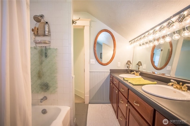 1510 Water St SW, Olympia, WA 98501 - bathroom featuring vaulted ceiling, double vanity, shower / bathtub combination with curtain, a textured ceiling, and wainscoting