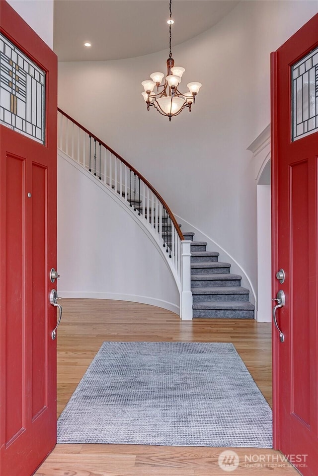 1122 140th Ave SE, Bellevue, WA 98005 - foyer featuring stairs, a chandelier, wood finished floors, recessed lighting, and a high ceiling