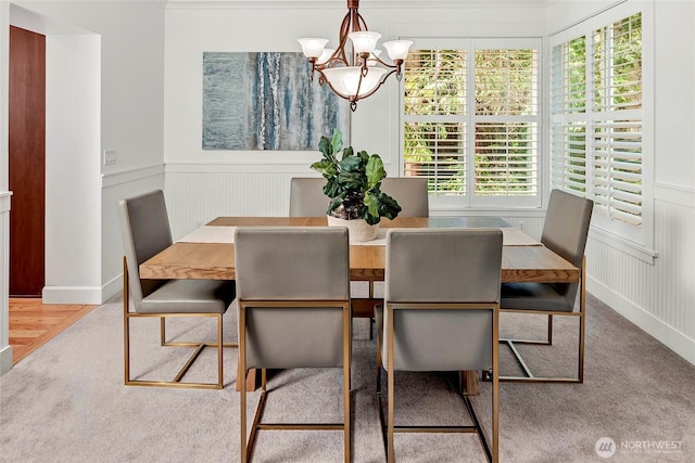 1122 140th Ave SE, Bellevue, WA 98005 - carpeted dining space featuring a chandelier, a decorative wall, and wainscoting