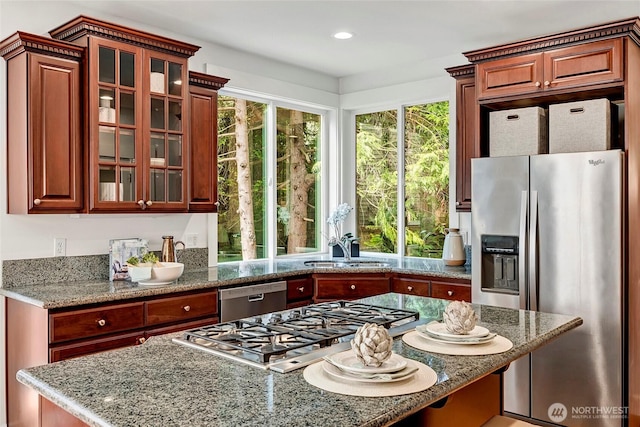 1122 140th Ave SE, Bellevue, WA 98005 - kitchen with appliances with stainless steel finishes, a sink, light stone countertops, glass insert cabinets, and recessed lighting
