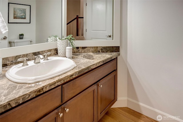 1122 140th Ave SE, Bellevue, WA 98005 - bathroom with vanity, wood finished floors, baseboards, and toilet