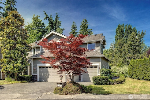 1122 140th Ave SE, Bellevue, WA 98005 - view of property hidden behind natural elements featuring an attached garage, asphalt driveway, a front lawn, and a shingled roof