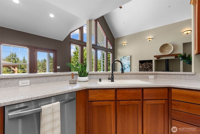 24022 SE 384th St, Enumclaw, WA 98022 - kitchen with dishwasher, vaulted ceiling, a sink, healthy amount of natural light, and brown cabinetry
