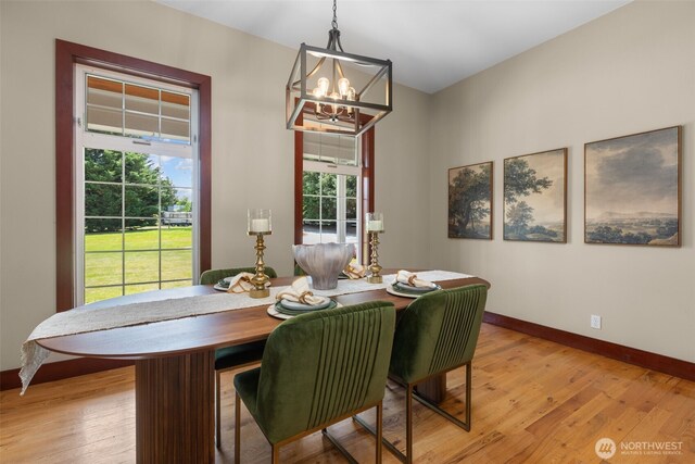 24022 SE 384th St, Enumclaw, WA 98022 - dining room with a chandelier, healthy amount of natural light, baseboards, and light wood-style floors