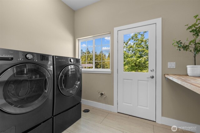 24022 SE 384th St, Enumclaw, WA 98022 - washroom featuring washing machine and dryer, baseboards, and light tile patterned floors