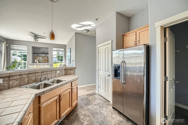 1855 Trossachs Blvd SE Unit 1404, Sammamish, WA 98075 - kitchen featuring stainless steel fridge, tile counters, a sink, baseboards, and decorative backsplash