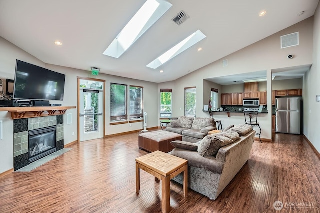 1855 Trossachs Blvd SE Unit 1404, Sammamish, WA 98075 - living area with light wood-style floors, a tiled fireplace, baseboards, recessed lighting, and high vaulted ceiling