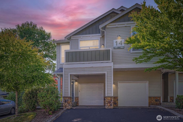 1855 Trossachs Blvd SE Unit 1404, Sammamish, WA 98075 - view of front facade featuring a garage, board and batten siding, a balcony, and stone siding