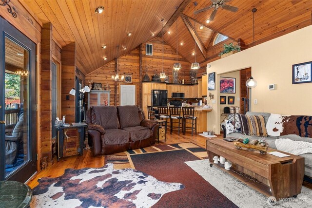 505 SW 19th St, Chehalis, WA 98532 - living area with a chandelier, hardwood / wood-style flooring, wood walls, wooden ceiling, and high vaulted ceiling