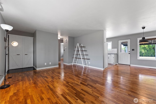 1115 S Evergreen Dr, Moses Lake, WA 98837 - unfurnished living room featuring wood finished floors and baseboards