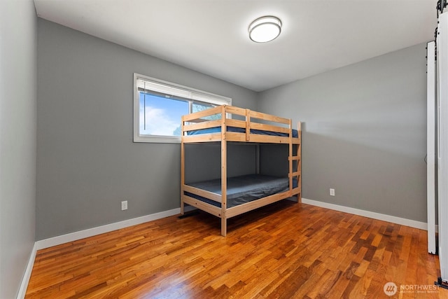 1115 S Evergreen Dr, Moses Lake, WA 98837 - unfurnished bedroom with wood finished floors and baseboards