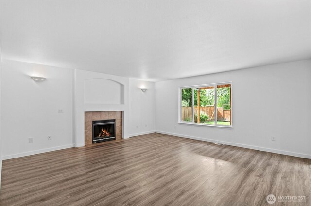 13924 Dogwood Ct, Sultan, WA 98294 - unfurnished living room featuring wood finished floors, a fireplace, and baseboards