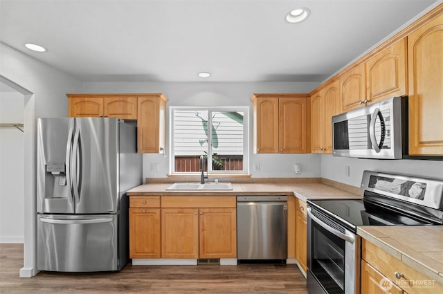 13924 Dogwood Ct, Sultan, WA 98294 - kitchen with appliances with stainless steel finishes, a sink, recessed lighting, wood finished floors, and light brown cabinetry