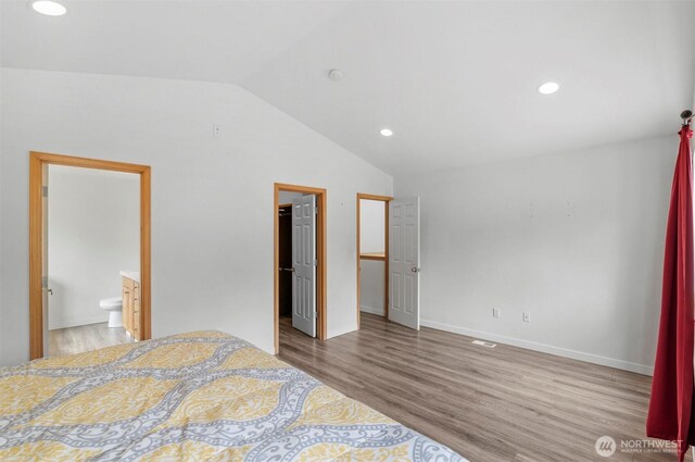 13924 Dogwood Ct, Sultan, WA 98294 - unfurnished bedroom featuring lofted ceiling, wood finished floors, recessed lighting, a spacious closet, and baseboards