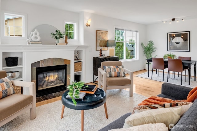 1824 23rd Ave Unit B, Seattle, WA 98122 - living room featuring wood finished floors, a tiled fireplace, and rail lighting
