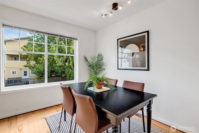 1824 23rd Ave Unit B, Seattle, WA 98122 - dining room with baseboards, wood finished floors, and track lighting