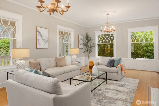 1611 Mcgilvra Blvd E, Seattle, WA 98112 - living room featuring a chandelier, crown molding, wood finished floors, and wainscoting
