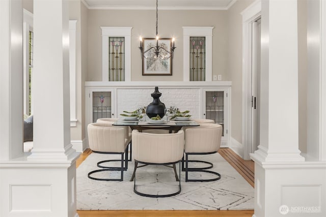 1611 Mcgilvra Blvd E, Seattle, WA 98112 - dining area with a chandelier, light wood-type flooring, ornamental molding, and baseboards