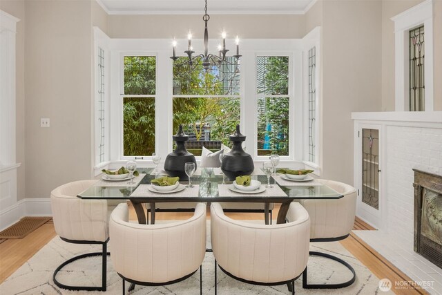 1611 Mcgilvra Blvd E, Seattle, WA 98112 - dining area featuring a brick fireplace, breakfast area, healthy amount of natural light, light wood-type flooring, and ornamental molding