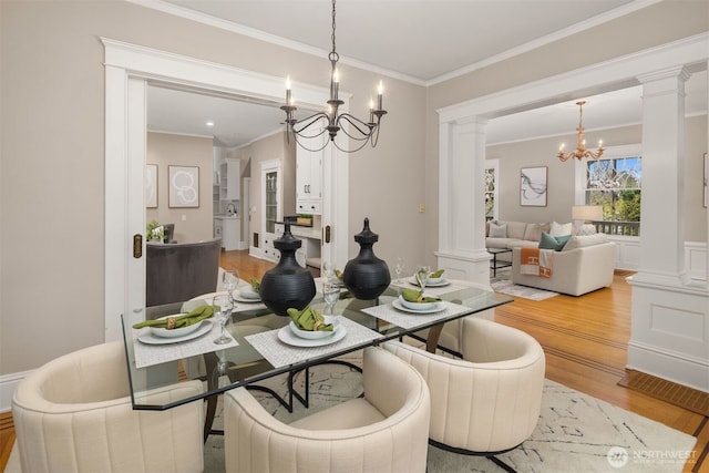 1611 Mcgilvra Blvd E, Seattle, WA 98112 - dining area with a chandelier, ornate columns, light wood-type flooring, and ornamental molding
