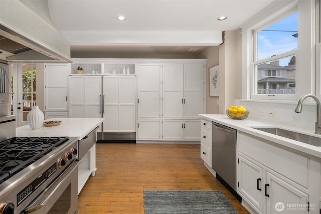 1611 Mcgilvra Blvd E, Seattle, WA 98112 - kitchen with stainless steel appliances, a sink, white cabinets, healthy amount of natural light, and recessed lighting