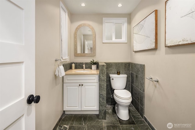 1611 Mcgilvra Blvd E, Seattle, WA 98112 - half bath with vanity, toilet, tile walls, recessed lighting, and a wainscoted wall