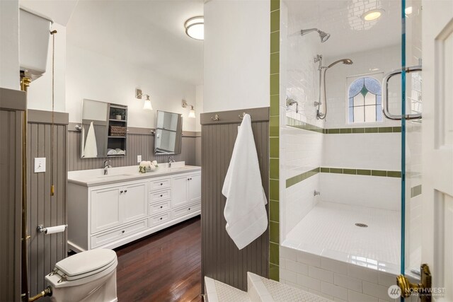 1611 Mcgilvra Blvd E, Seattle, WA 98112 - full bath featuring tiled shower, double vanity, a wainscoted wall, toilet, and wood finished floors