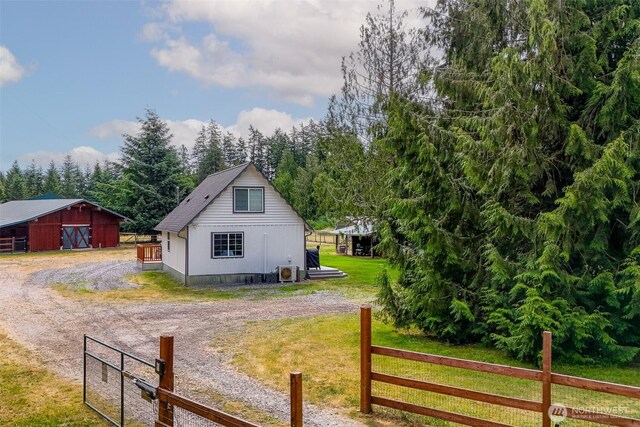 14938 Frenchie Ln SE, Yelm, WA 98597 - view of side of home featuring dirt driveway and an outdoor structure