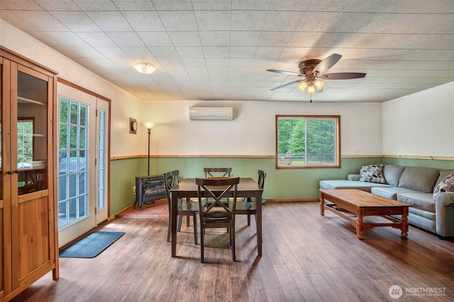 14938 Frenchie Ln SE, Yelm, WA 98597 - dining space featuring a wall mounted AC, wood finished floors, and ceiling fan