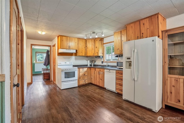 14938 Frenchie Ln SE, Yelm, WA 98597 - kitchen with white appliances, under cabinet range hood, dark countertops, and dark wood-style floors