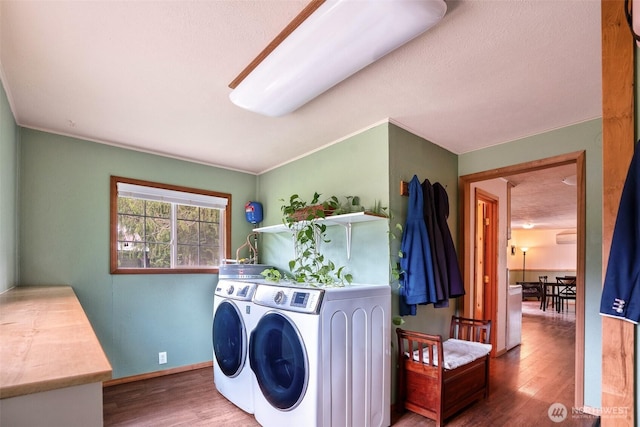 14938 Frenchie Ln SE, Yelm, WA 98597 - washroom with washing machine and clothes dryer and wood finished floors