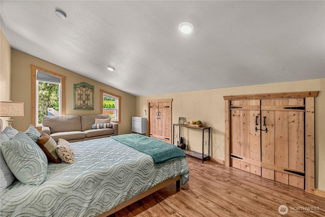 9377 Lone Pine Orchards, Leavenworth, WA 98826 - bedroom with light wood-type flooring, vaulted ceiling, baseboards, and recessed lighting