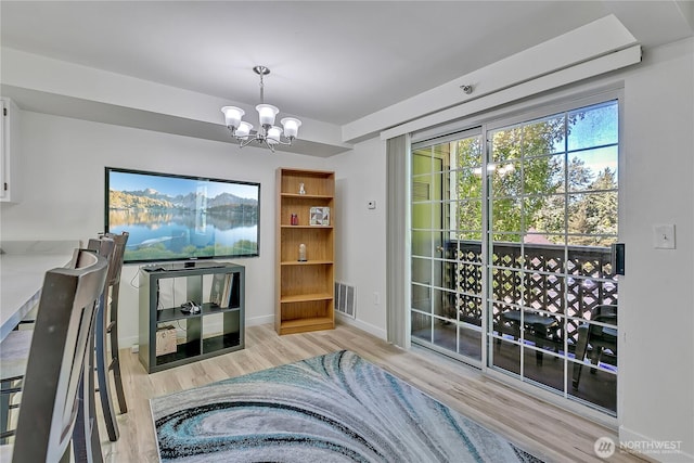 3939 10th St SE Unit A2, Puyallup, WA 98374 - living area with a chandelier, wood finished floors, and baseboards