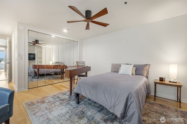 98 Union St Unit 301, Seattle, WA 98101 - bedroom featuring wood finished floors, a closet, and a ceiling fan