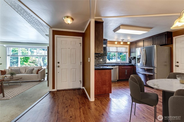 5611 128th Pl SE, Everett, WA 98208 - kitchen featuring appliances with stainless steel finishes, open floor plan, dark wood-style flooring, dark countertops, and crown molding