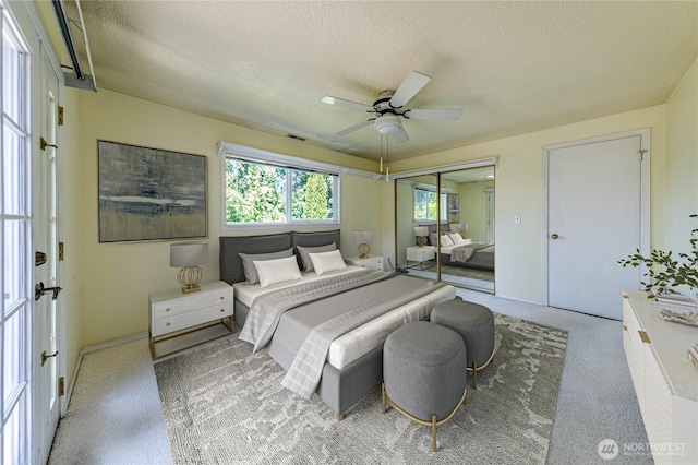 5611 128th Pl SE, Everett, WA 98208 - bedroom with a textured ceiling, carpet, ceiling fan, baseboards, and a closet